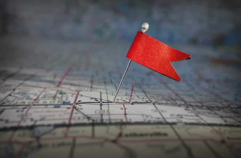 small red flag pinned to map